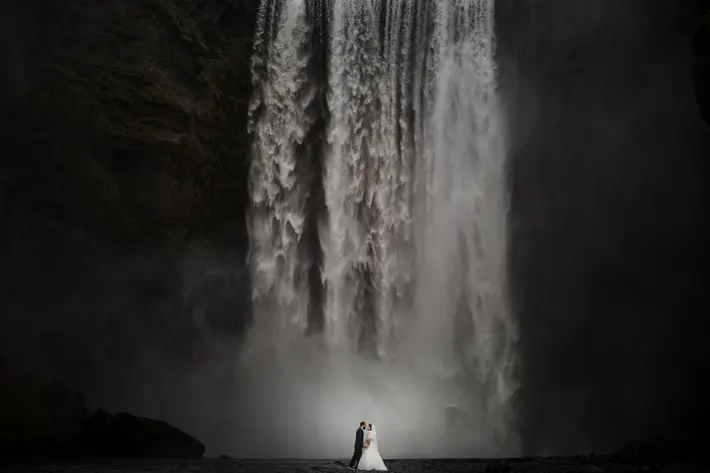 Skogafoss- Iceland-dramatic-bride-and-groom-shot-by-waterfall-susan-stripling-nyc-wedding-photographer