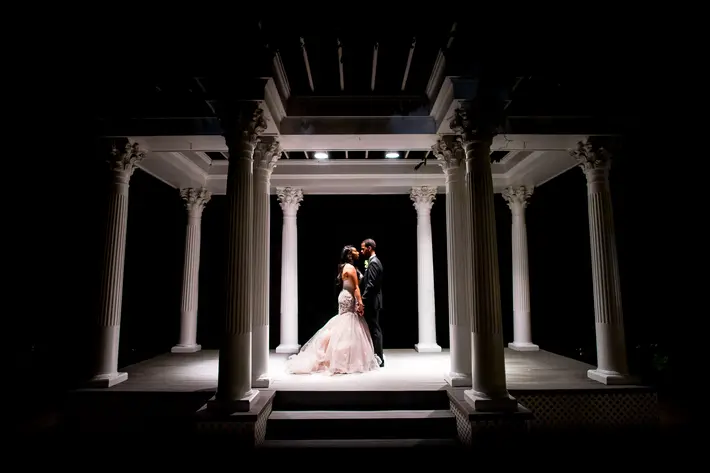 nighttime-bride-and-groom-portrait-under-gazebo-photo-by-adibe-photography
