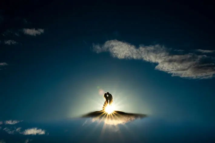 Couple walking on sunlit clouds - award-winning engagement photo by J. LaPlante - Colorado