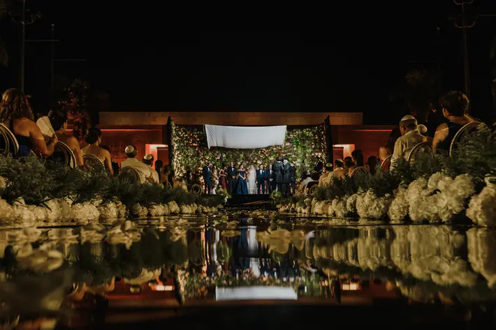 elaborate-floral-wall-ceremony-reflected-in-pool-elmarcorojo-spain