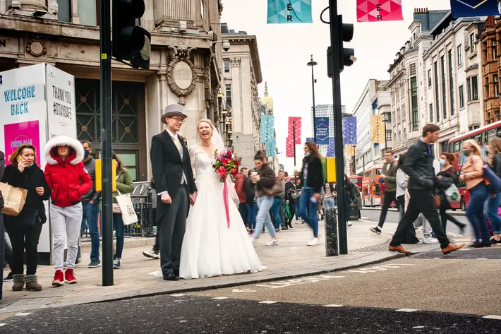Just married couple on busy London street - photographed by Andrew Billington