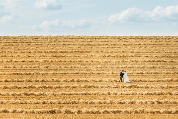 landscape-couple-in-hay-field-sylvain-bouzat-wedding-photographer
