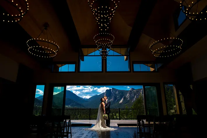 mountain-venue-with-couple-framed-by-large-window-with-epic-view-j-la-plante-photo