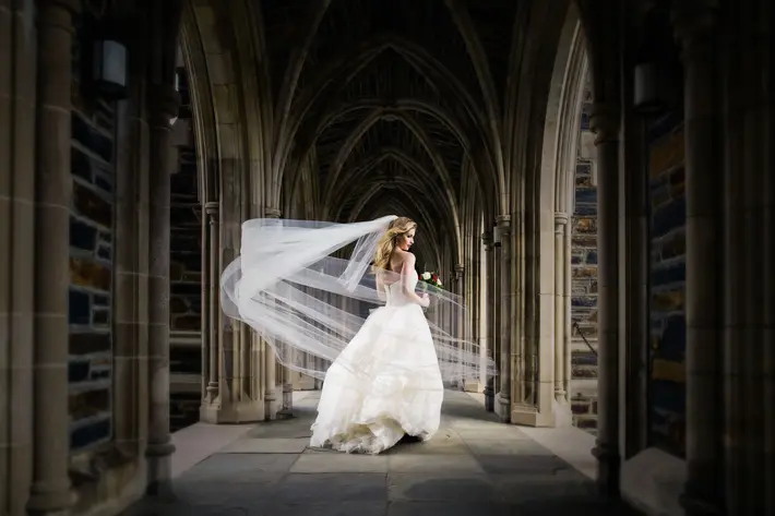 Long-wedding-veils-bride-portrait-in-gothic-architecture-joe-payne-photography