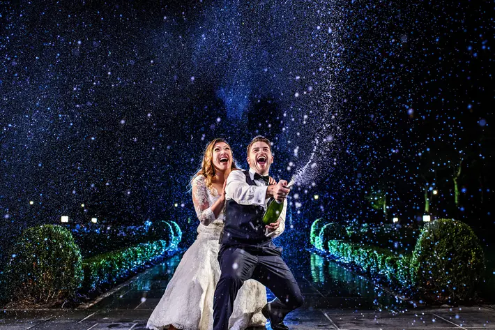 Couple pops champage on a starry night - photo by Jeff Tisman - NYC wedding photographer
