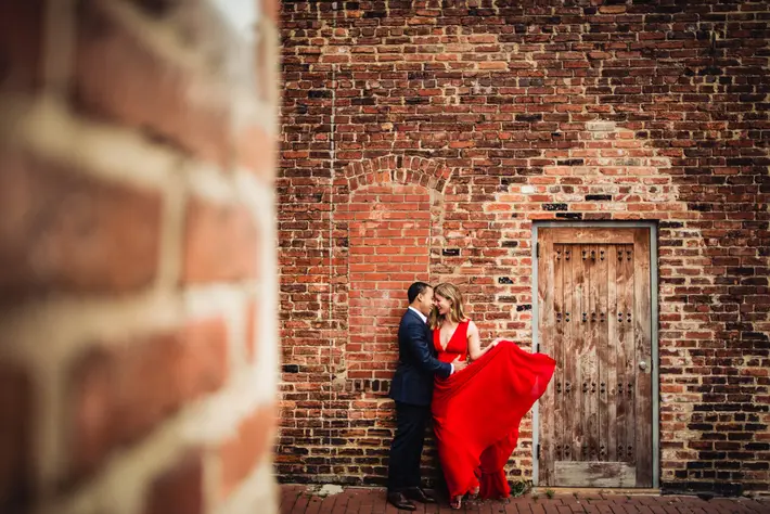 engagement-couple-red-dress-against-brick-wal-so-tender-is-humanity
