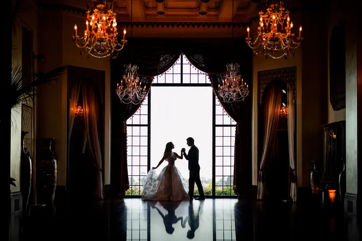 best-wedding-silhouette-award--winner-couple-dancing-against-floor-to-ceiling-window-m-hart-photography-los-angeles