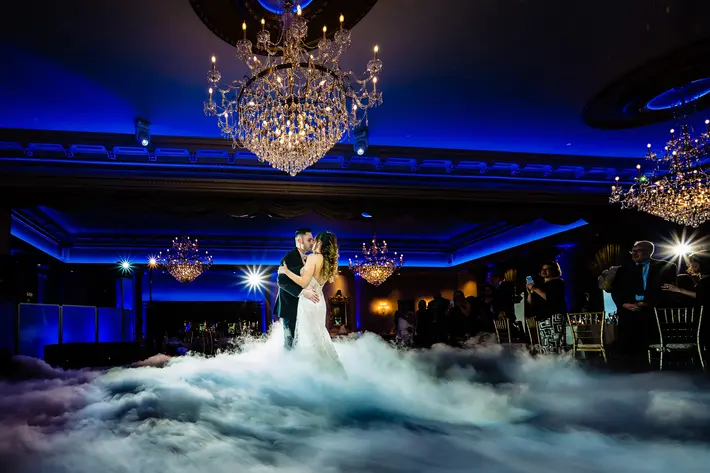 couple-on-dance-floor-amidst-blue-smoke-at-luciens-manor-smj-photography