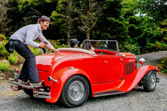 Photographer ride on the back of red Rolls Royce, - Jos and Tree - Portland, OR