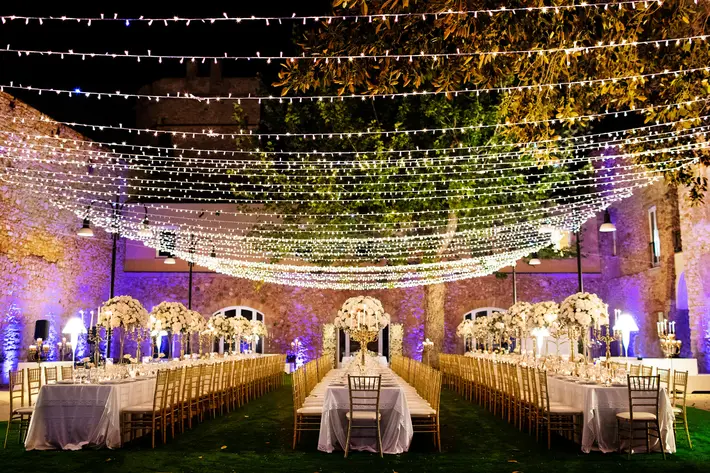 long-reception-tables-under-strings-of-lights-nino-lombardo-photographer