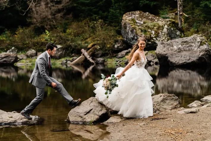 couple-crossing-rocks-over-lake-photo-by-amy-galbraith-photography
