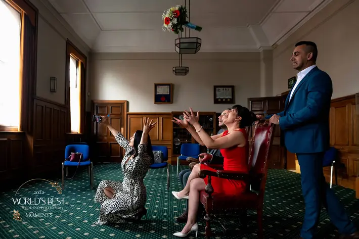Seated guests at courthouse ready to catch the bouquet - photo by Rich Howman - UK wedding photographer