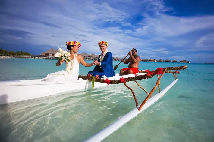 couple-with-floral-crowns-riding-in-catamaran-callaway-gable