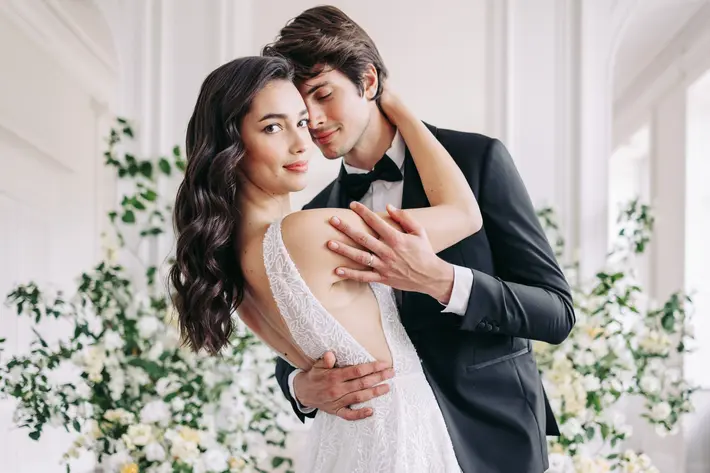 groom-leans-in-as-bride-faces-camera-photo-by-amandine-ropars