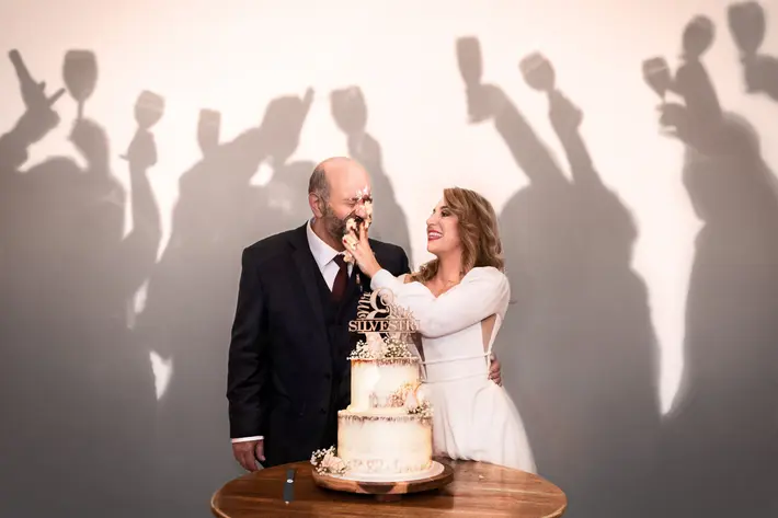 silly-cake-moment-with-shadows-of-guests-with-raised-glasses-dezine-by-mauro