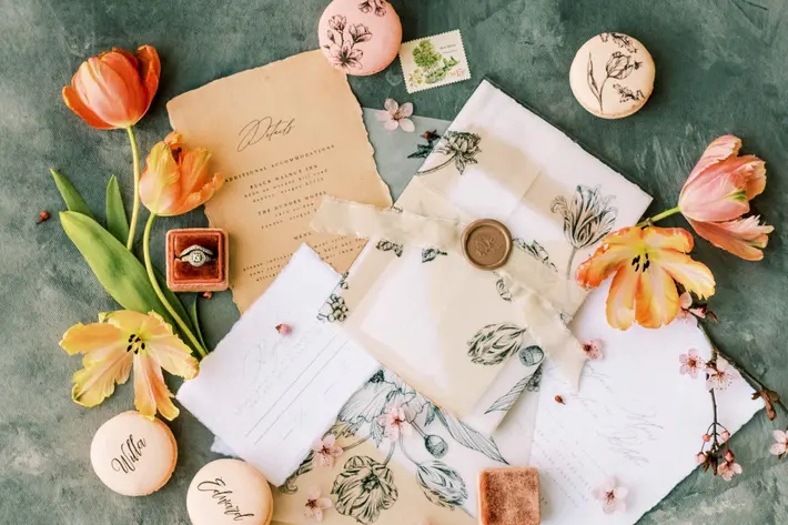 flat-lay-with-stationery-painted-macarons-and-flowers-photo-by-lauryn-kay-photography