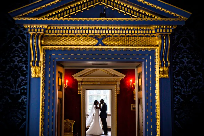 couple-face-to-face-under-ornate-gold-doorway-worlds-best-wedding-photos-jide-alakija-new-york-wedding-photographers