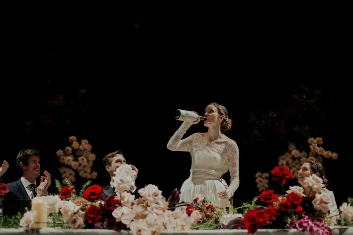 Bride drinking champagne from bottle during wedding toast, Dan O'Day Photography, Australia