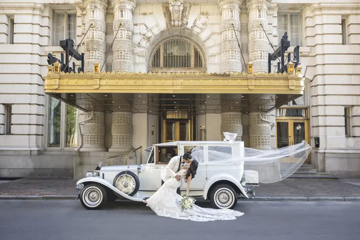 kiss by antique car at the Belvedere Hotel Anna Schmidt Photography
