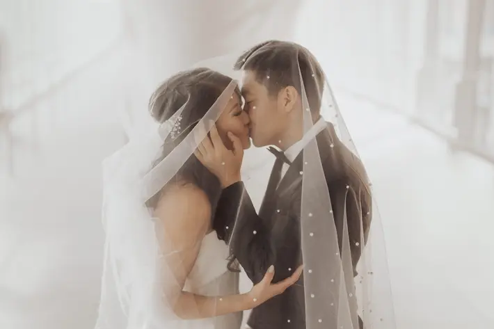 Couple kiss under veil Kristin Hahn Photography