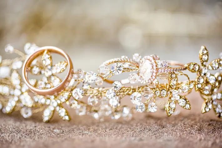 Oval diamond halo ring displayed on diamond tiara Anna Schmidt Photography