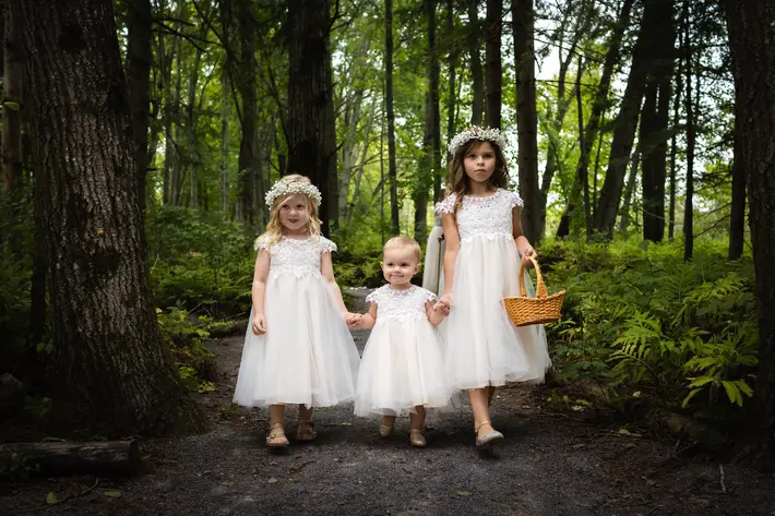 Three adorable flower girls on path in woods Alecia and Patrick