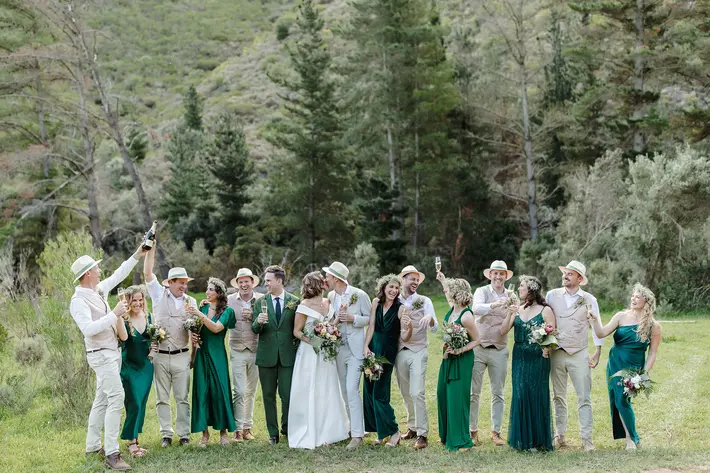 Wedding party group shot in green and tan with hats Ruan Redelinghuys Photography South Africa wedding photographer