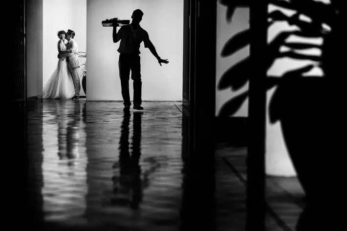 Sneaking a kiss during preparations Chrisman Studios Charleston South Carolina