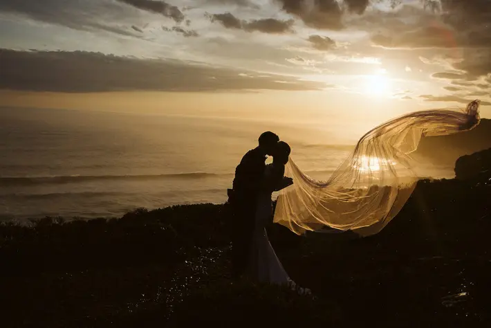 Silhouette couple at sunset on beach Jack Hoyle Detroit Michigan based wedding photographer