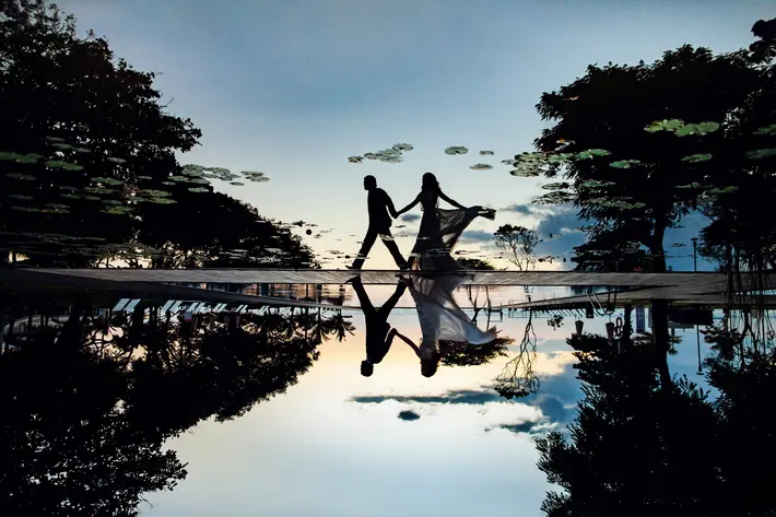 Couple silhouettes walking with reflection photo by Paolo and Barbara Orsolini