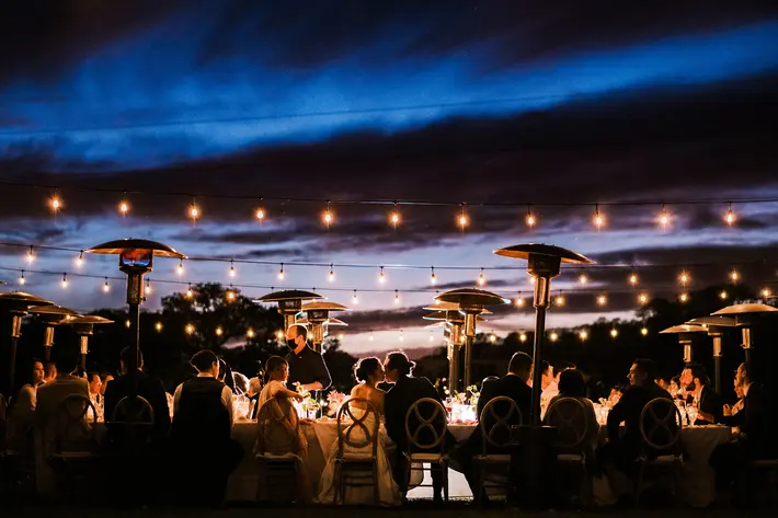 Festive evening reception table with string lights photo by Chrisman Studios