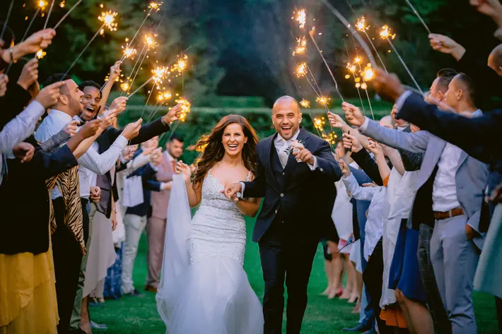 Happy couple runs through send off of sparklers Peter van der Lingen