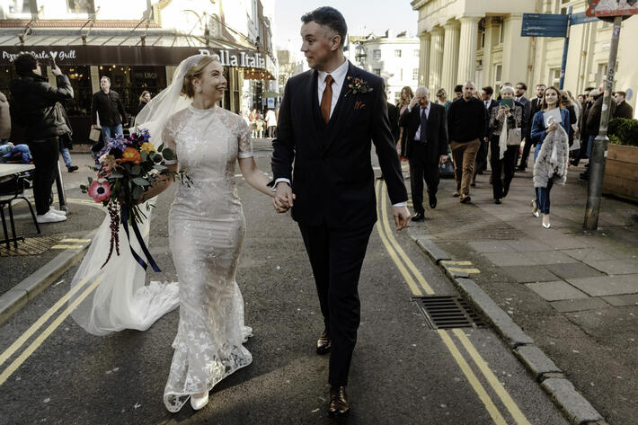 Couple walking on street Brighton Town Hall wedding Oliver Holder Photography Bristol Wedding Photographer